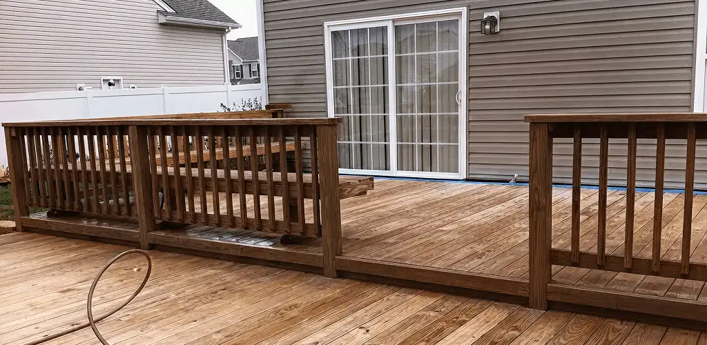 Deck sealing service protecting a backyard wood deck and railings in Indianapolis, IN