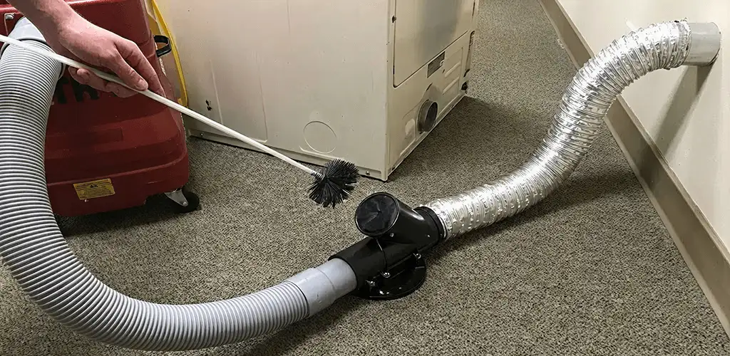 Dryer vent cleaning service removing lint from a dryer duct connection in Indianapolis, IN