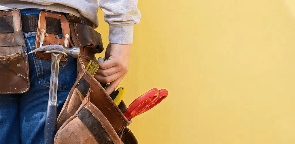 Handyman with tool belt ready for home repairs and maintenance in Indianapolis, IN