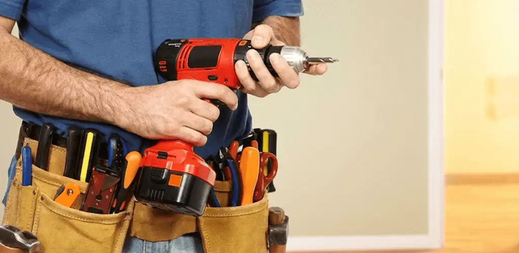 Handyman holding a power drill for home repairs and installations in Indianapolis, IN