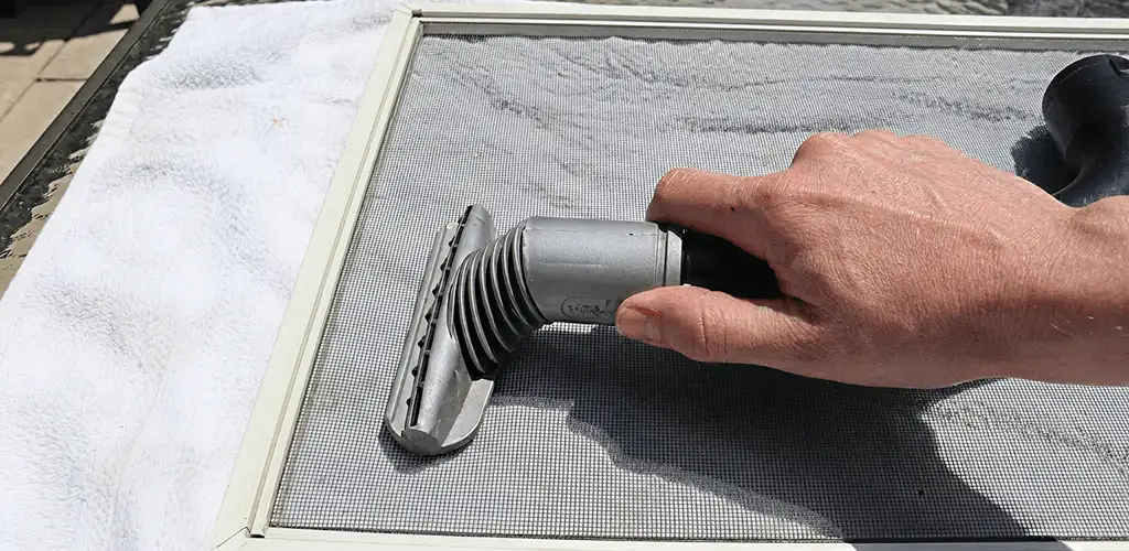 Window screen repair cleaning and fixing a damaged screen mesh in Indianapolis, IN